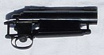 Left-handed Remington 700 rifle action—note that the bolt handle is not visible from this side