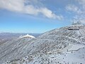 Part of Las Campanas Observatory after snowfall, with the Magellan telescopes at the right.