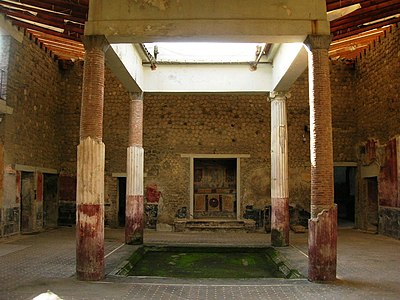 Atrium tetrastylum, four pillars. Villa San Marco, Stabiae. In this image, the atrium is roofed by a white tarp, laced down at the eaves and supported by scaffolding.
