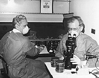 Centers for Disease Control medical technologist George Gorman (left) and Jim Feeley, examining culture plates upon which the first environmental isolates of Legionella pneumophila had been grown