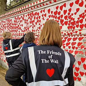Volunteers painting hearts at the National Covid Memorial Wall