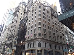 The rounded corner of the building as viewed from across the intersection of Fifth Avenue and 54th Street