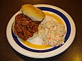 A barbecue pulled-pork sandwich with a side of coleslaw