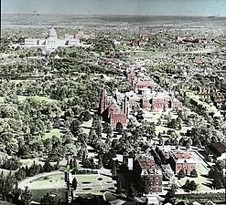The Victorian landscaping and architecture of the Mall looking east from the top of the Washington Monument, showing the influence of the Downing Plan and Adolph Cluss on the National Mall circa 1904. The Department of Agriculture Building, and above it, "The Castle", are in the foreground. A railroad route leading to a shed attached to the Baltimore and Potomac Railroad station (not visible) crosses the Mall behind the Arts and Industry Building, the Army Medical Center, and the Armory.