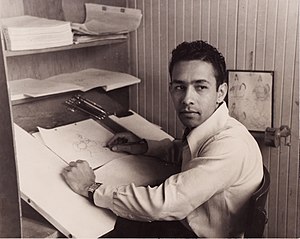 Larriva seated at his artist desk