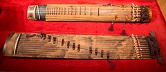 Geomungo and gayageum instruments on display in a museum