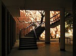 Interior of a modernist building with columns and a staircase