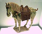 A Chinese Tang dynasty tri-color glazed porcelain horse (c. 700 AD), using yellow, green and white colors.