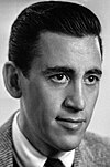 A photograph of J.D. Salinger, wearing a suit and sporting dark, combed hair