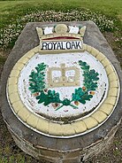 An outdoor stonework feature depicting a crown with a laurel wreath, topped by the words Royal Oak