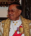 Chai Chidchob wears the Second-Class Ministerial Gown (ครุยเสนามาตย์ชั้นโท; Khrui Senamat Chan Tho). A recipient of the first or second class of the Order of Chula Chom Klao is entitled to wear this gown.