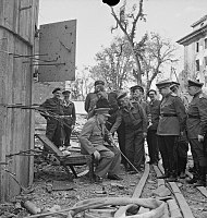 Winston Churchill sitting on a damaged chair from the Führerbunker in July 1945