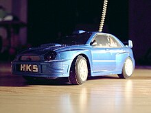 A toy size blue Subaru Impreza.
