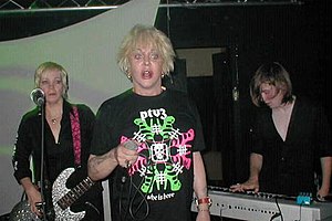 Psychic TV performing in Cologne in 2004. Left to right: Alice Genese (bass), Genesis P-Orridge (vocals), Markus Person (keyboards).