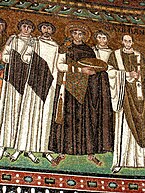 Justinian I and ministers wear early Byzantine ceremonial chlamydes, Ravenna mosaic.