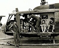 RVNAF Huey full of evacuees on the deck of USS Midway