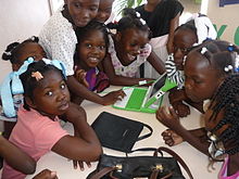 Photo of a group of children being introduced to a laptop