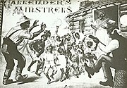 Blackface performers, mostly children, dance a jig in front of a log cabin, with a "mammie" standing in the doorway grinning widely.
