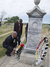 US Attorney General Eric Holder laying a wreath at the site of the Wounded Knee Memorial