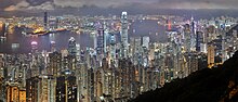 A panorama overlooking the skyscrapers of Hong Kong at night, with Victoria Harbour in the background