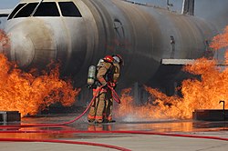Airmen from the 312th Training Squadron extinguish a fire on a training module to demonstrate an aircraft incident at Goodfellow AFB.