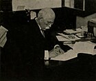 Black-and-white photo of Sutton working