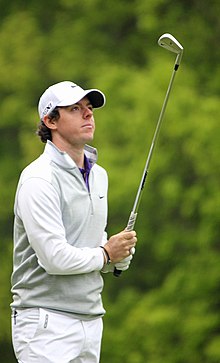 Rory McIlroy looking at his club.