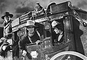 Left to right: George Bancroft, John Wayne and Louise Platt