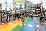 A crossing painted in the colours of the rainbow with the printed words TAIPEI in Taipei, Taiwan