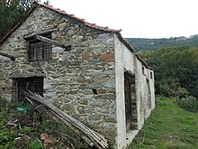 Photographs of a stone storage building with several windows