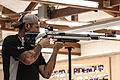 Competitor taking aim through a diopter and globe sighting line at the 2014 Warrior Games.