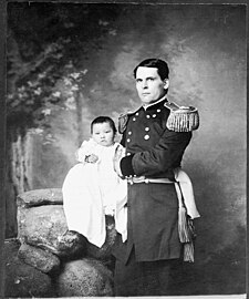 Gen. L. W. Colby holding Zintkála Nuni (Little Lost Bird), found alive on the snow-covered Wounded Knee field four days after the massacre, still tied to her dead mother's back
