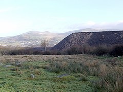 Slate tips on outer edges of Penrhyn Quarry at Mynydd Llandegai, the view looks out to Bethesda in the distance