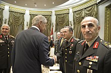 Mr Hagel, in a civilian suit, shakes hands with General Öztürk, in uniform.