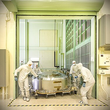 Engineering Test Unit (ETU) mirror segment being hauled into a cleanroom in its container, 2013