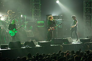 The Cure performing in August 2007. From left to right: Jason Cooper (on drums), Porl Thompson, Robert Smith, and Simon Gallup
