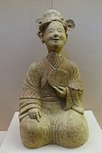 An Eastern Han ceramic figurine of a seated woman with a bronze mirror, unearthed from a tomb of Songjialin, Pi County, Sichuan