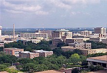 a skyline view of the Texas A&M campus. Dozens of buildings are visible including one that is domed