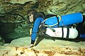 Left side view of sidemount diver in cave