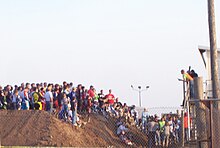 a group of people stand on a hill