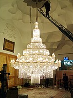 Large modern chandelier being worked on, Iran
