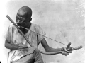 גבר מניגריה מנגן בקשת מוזיקלית.