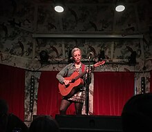 Veirs onstage playing guitar
