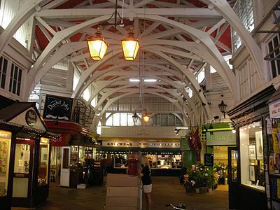 Inside the Covered Market, Oxford, England. Curved roof trusses imitate the form of a stone arcade.