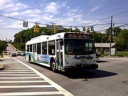 Maryland Transit Administration (MTA) bus passes through intersection of Frankford Avenue and Sinclair Lane in Frankford, Baltimore