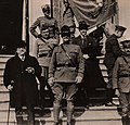 Mr. Samuel Gompers, the famous labor leader, poses for a photograph in front of an Italian villa with Colonel William Wallace, the commander of the 332nd Infantry Regiment, and Brigadier General Charles Treat. Note the 332nd Colors in the background. 12 October 1918. Courtesy National Archives.