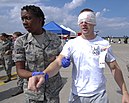 An U.S. Air Force emergency responder from the 35th Medical Group evacuates a simulated casualty during a major accident response exercise at Misawa Air Base.