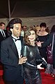 Paula Abdul modeling a semi-transparent black dress, curled hair and smoky eye makeup at the 62nd Academy Awards in 1990