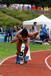 This sprinter's initial crouch in the blocks allowed her to preload her muscles and channel the force generated from this into her first strides forwards.