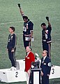 Gold medalist Tommie Smith (center) and bronze medalist John Carlos (right) showing the raised fist on the podium after the 200 m race at the 1968 Summer Olympics